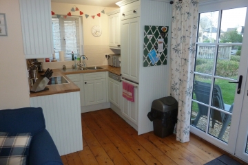 Kitchen area with doors to garden
